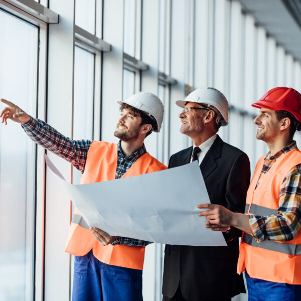 Architect man showing something on project to his colleague foreman.